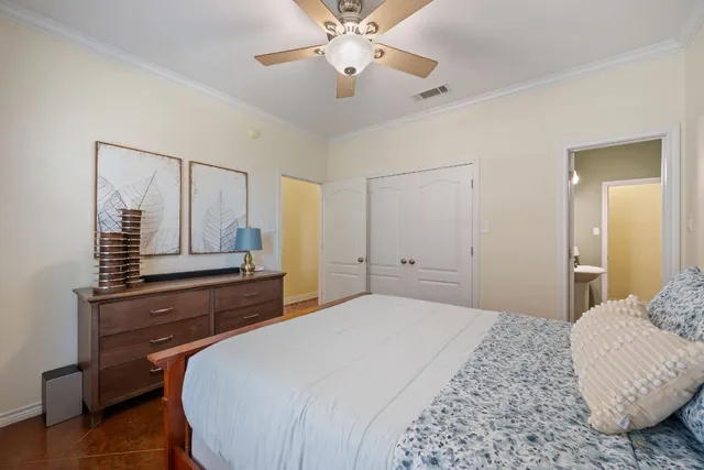 a bedroom with a bed and a chandelier