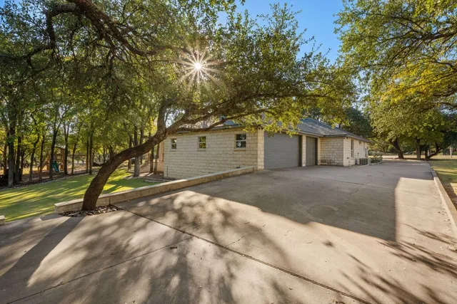 a view of a house with backyard and a tree