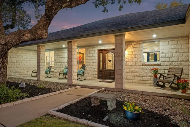a front view of a house with outdoor seating