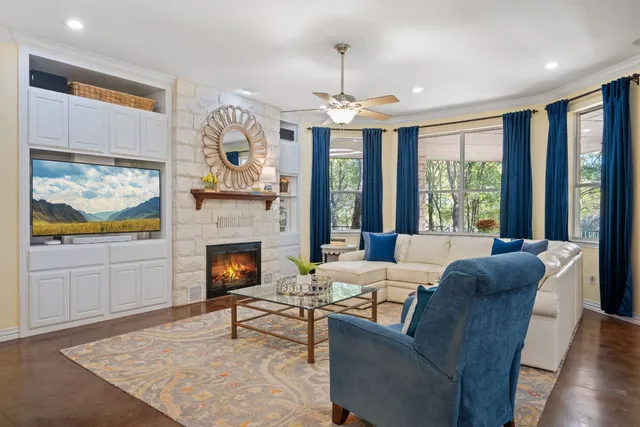 a living room with furniture a fireplace and a flat screen tv