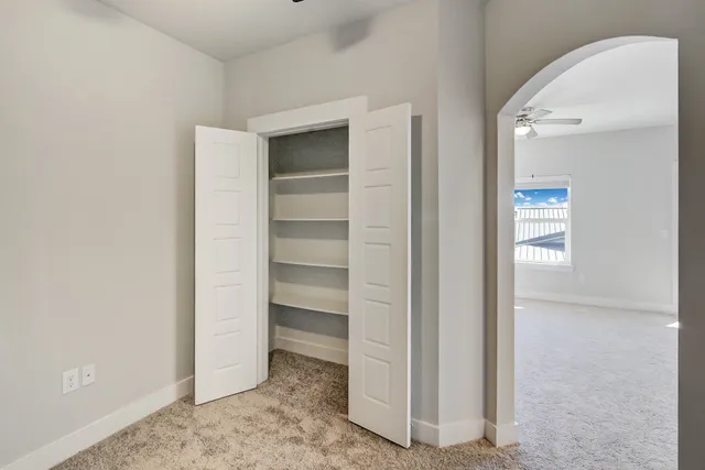 a view of walk in closet with empty racks