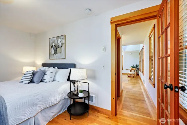 a bedroom with a bed and a lamp on table
