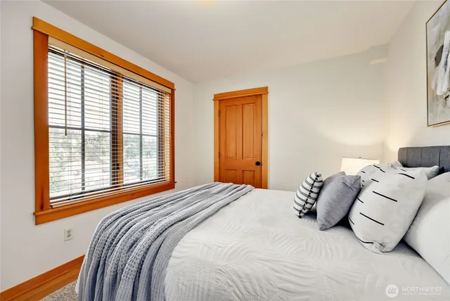 a bedroom with a bed and a large window