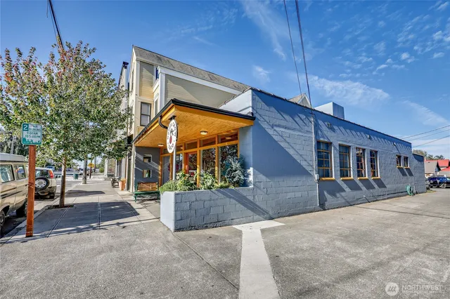 a view of a street with cars parked on the road