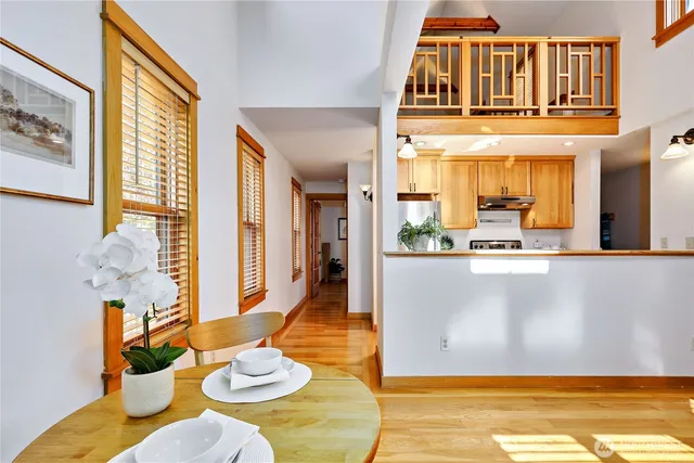a view of a dining room with furniture a chandelier and wooden floor