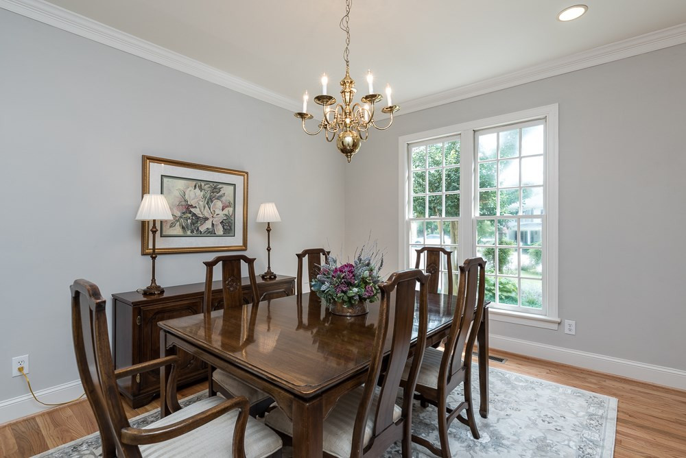 Dining room with 2 piece crown, storage closet, freshly painted walls and new hardwood floors. Dining Room