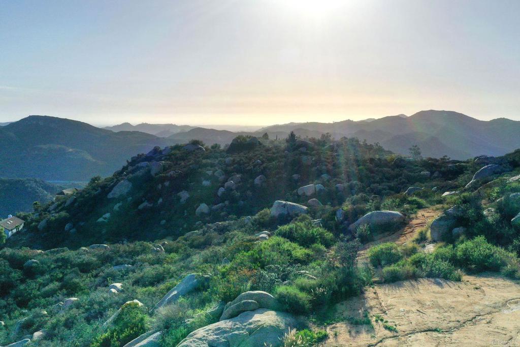 a view of a lush green hillside and a building