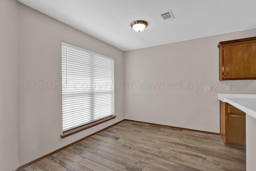 5236 Capulin Lane Amarillo, TX 79110 - Photo 17 of 24 a view of empty room with wooden floor and fan