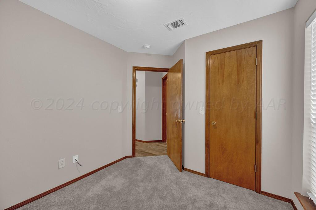 5236 Capulin Lane Amarillo, TX 79110 - Photo 18 of 24 a view of an empty room with closet and a window