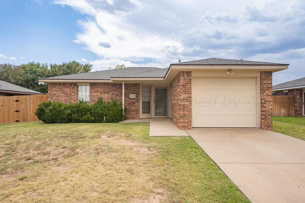 5236 Capulin Lane Amarillo, TX 79110 - Photo 4 of 24 a front view of a house with a yard and garage