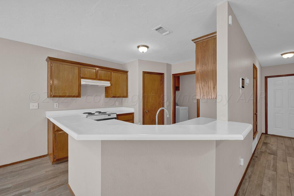 5236 Capulin Lane Amarillo, TX 79110 - Photo 6 of 24 a kitchen with stainless steel appliances a refrigerator and a stove