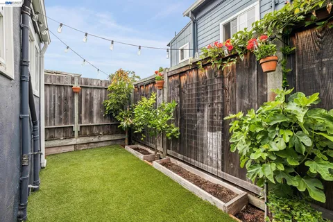 a backyard of a house with lots of green space and outdoor seating