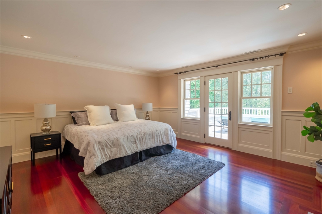 197 Grant Street Lexington, MA 02420 - Photo 19 of 42 a spacious bedroom with a bed and wooden floor