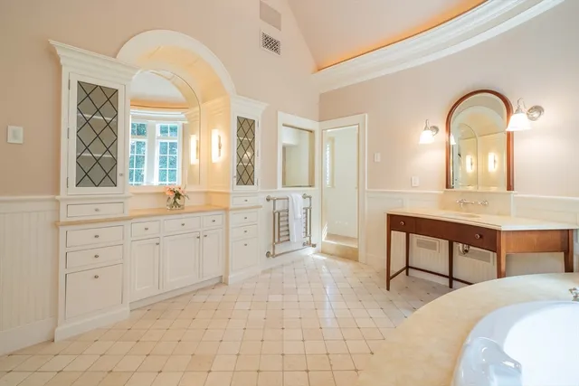 a bathroom with a tub shower and a sink