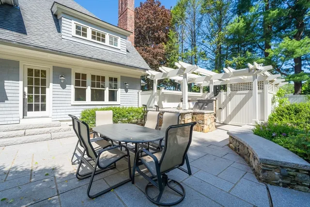 a view of a patio with table and chairs and potted plants