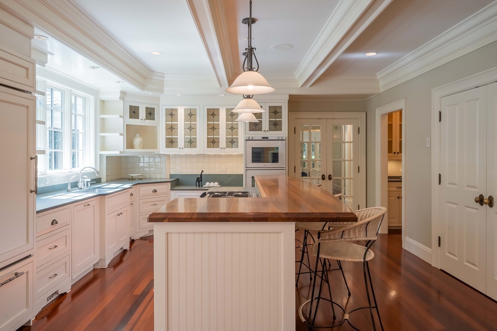 197 Grant Street Lexington, MA 02420 - Photo 10 of 42 a kitchen with center island wooden floor and white appliances