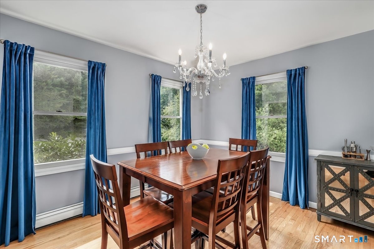 14 Philo Curtis Road Newtown, CT 06482 - Photo 8 of 34 Bright Dining Room with Three Large Windows Letting in the Serene Wooded Views