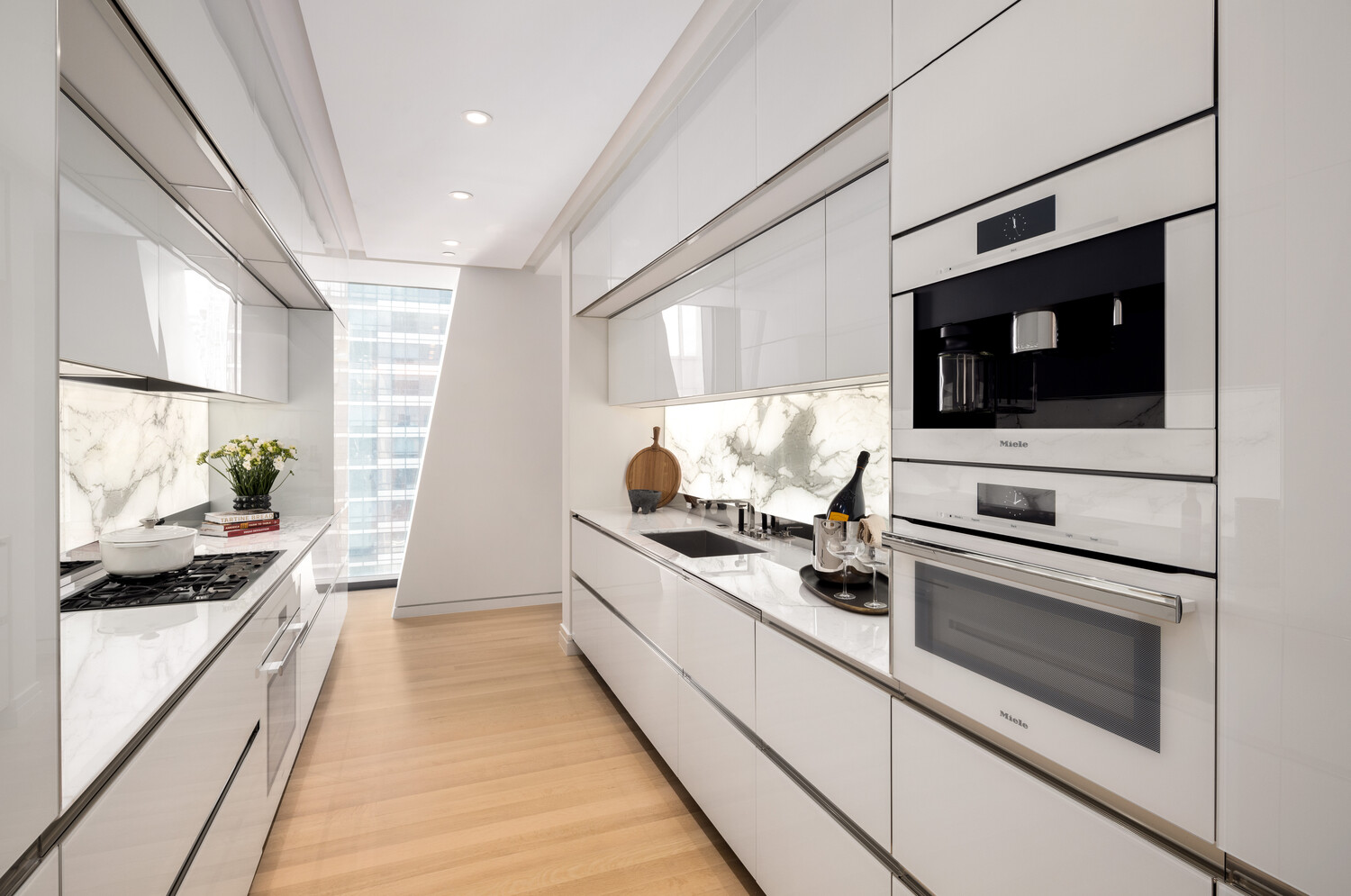 53 West 53rd Street, Unit 20D Manhattan, NY 10019 - Photo 3 of 12 a kitchen with stainless steel appliances kitchen island granite countertop a stove and a sink