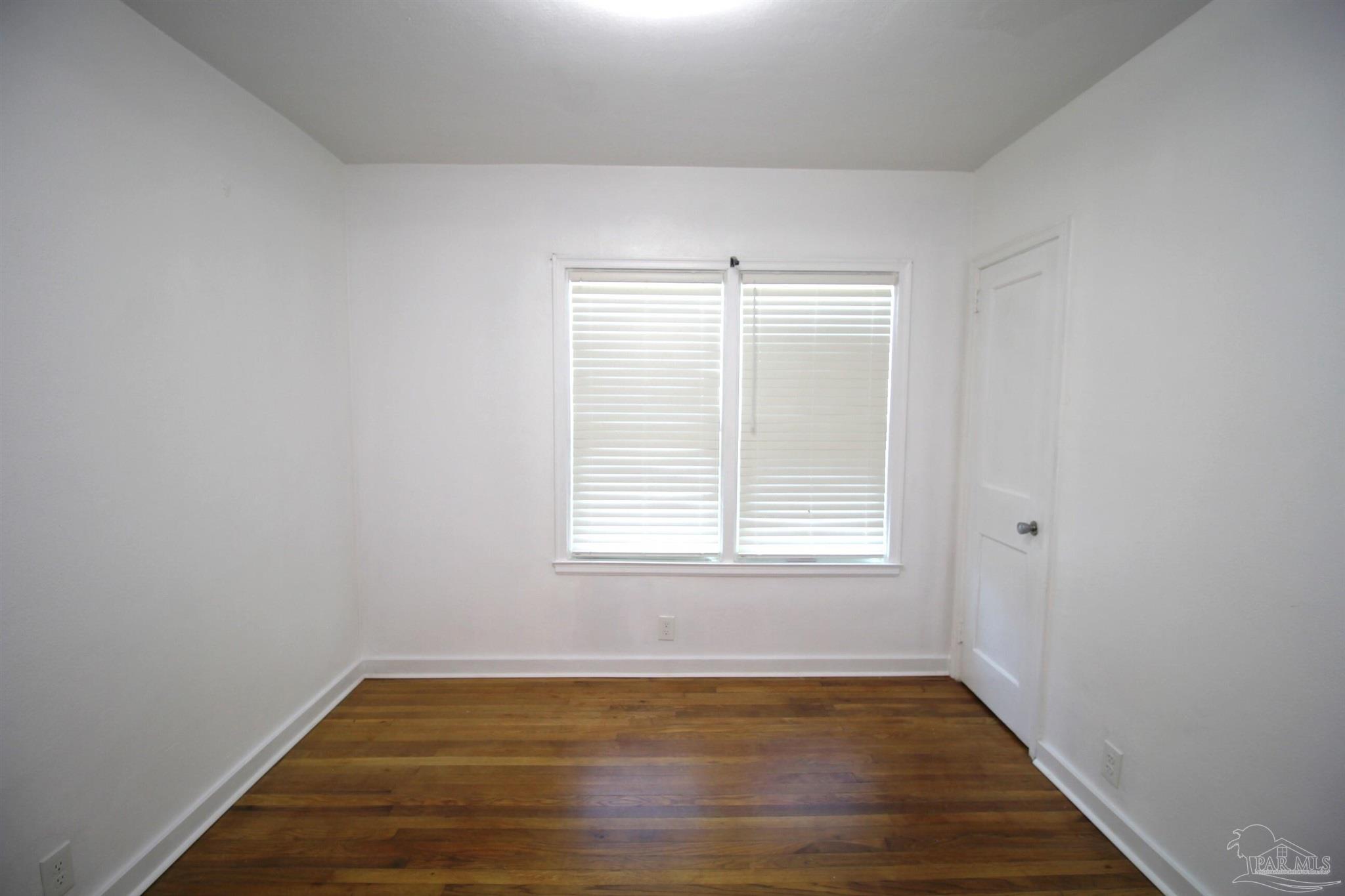 315 Flannan Road Pensacola, FL 32507 - Photo 14 of 17 an empty room with wooden floor and windows