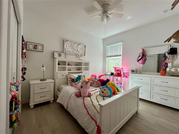 a bedroom with a bed couch and dresser