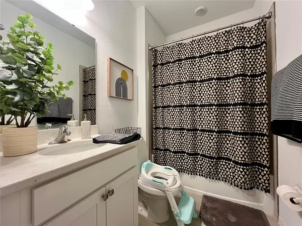a bathroom with a shower and a sink