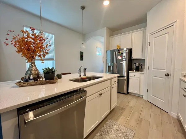a kitchen with stainless steel appliances a sink stove and refrigerator