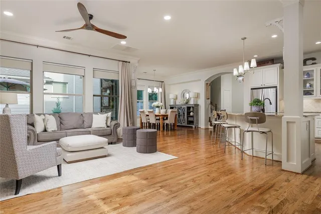 a living room with fireplace furniture and a chandelier