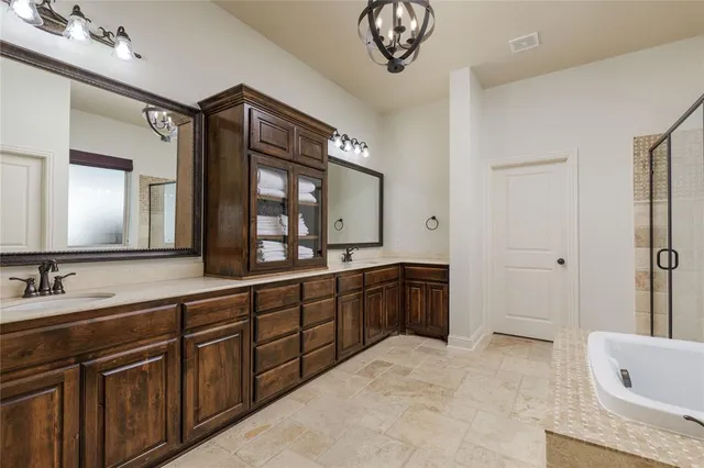 a spacious bathroom with a granite countertop sink mirror and bathtub