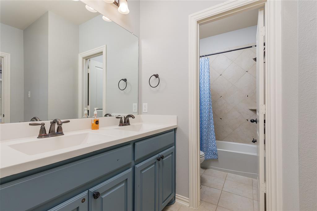 2205 State Boulevard McKinney, TX 75071 - Photo 21 of 40 Bathroom with vanity, shower / tub combo with curtain, and light tile patterned flooring