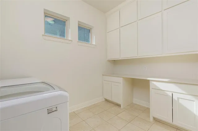 a view of storage and utility room with cabinets