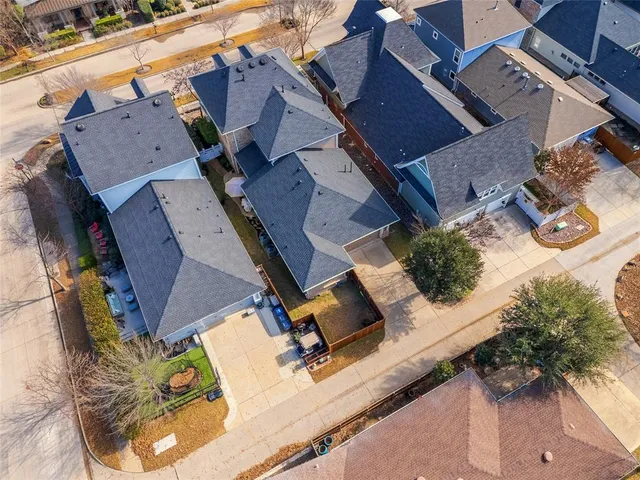 an aerial view of residential houses with outdoor space