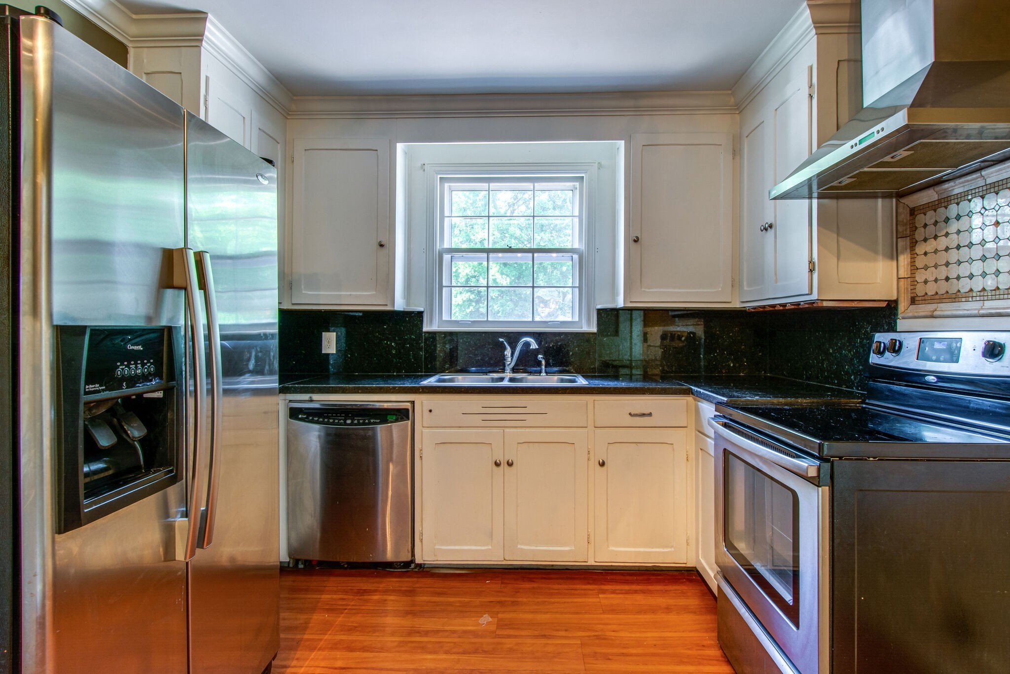 2302 Deerwood Road Nashville, TN 37214 - Photo 12 of 30 a kitchen with stainless steel appliances granite countertop a stove a sink and a microwave