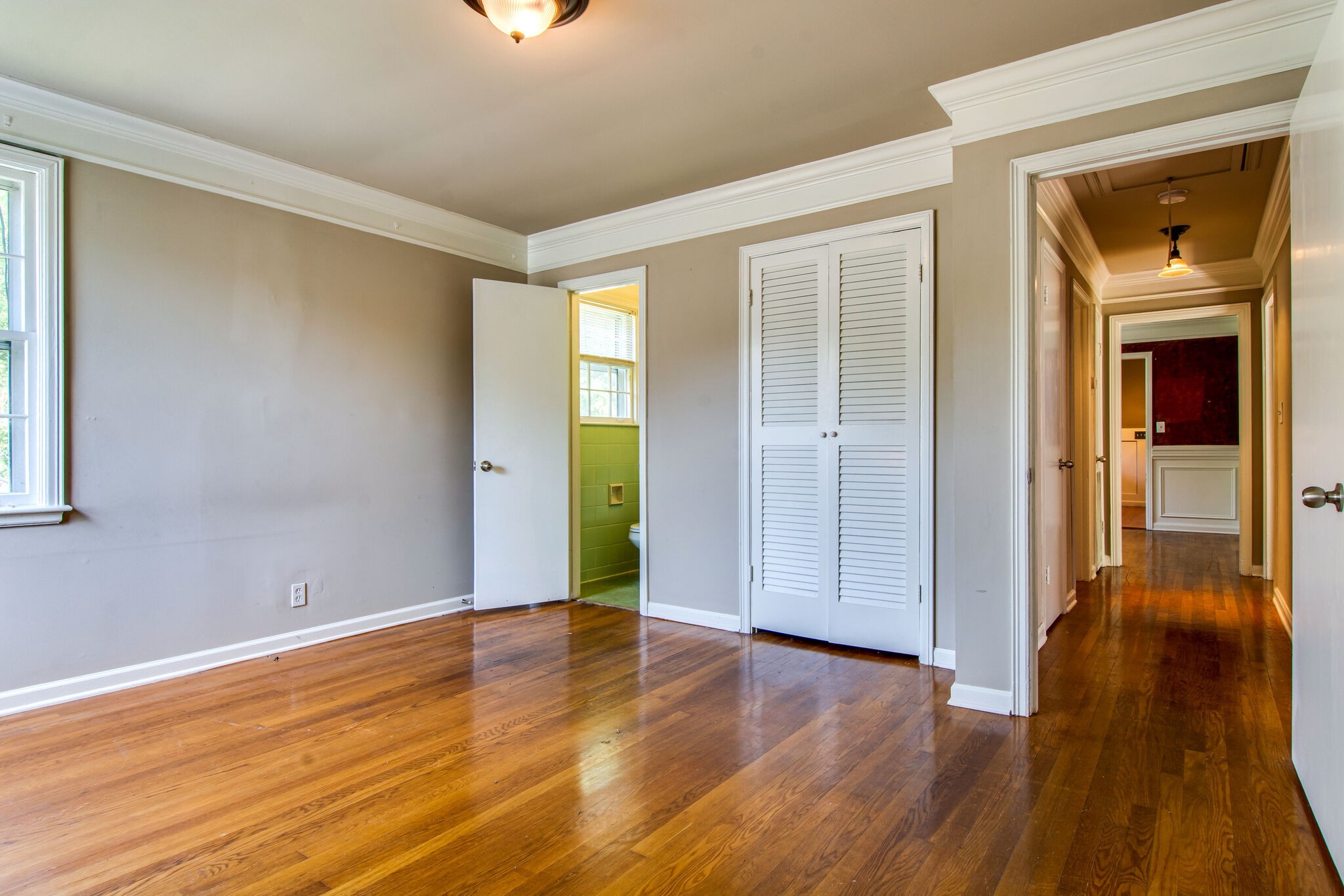 2302 Deerwood Road Nashville, TN 37214 - Photo 15 of 30 a view of an empty room with wooden floor and a window