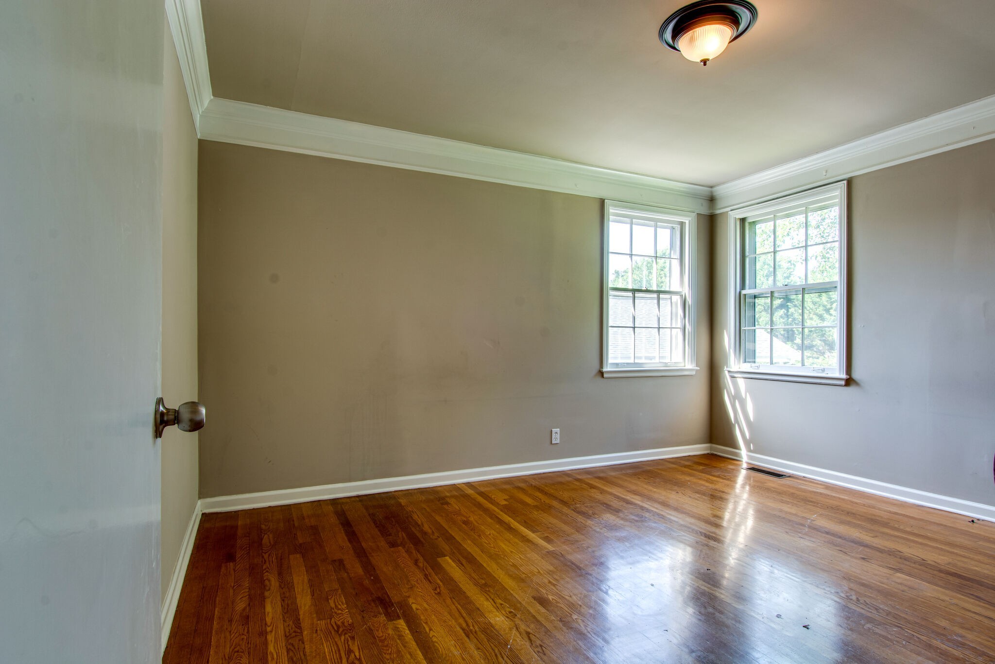 2302 Deerwood Road Nashville, TN 37214 - Photo 18 of 30 an empty room with wooden floor and windows