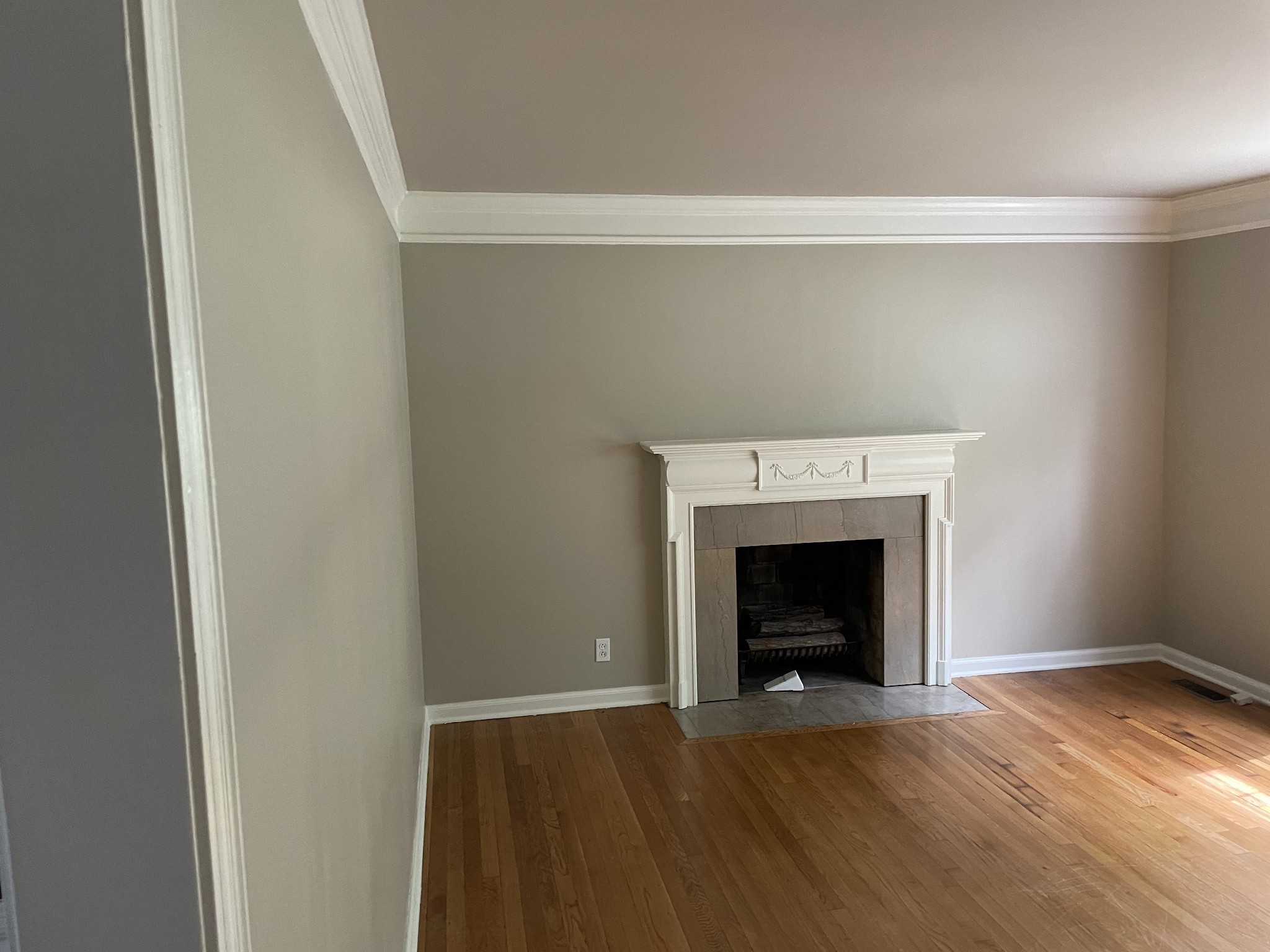 2302 Deerwood Road Nashville, TN 37214 - Photo 4 of 30 a view of an empty room with wooden floor fireplace and a window