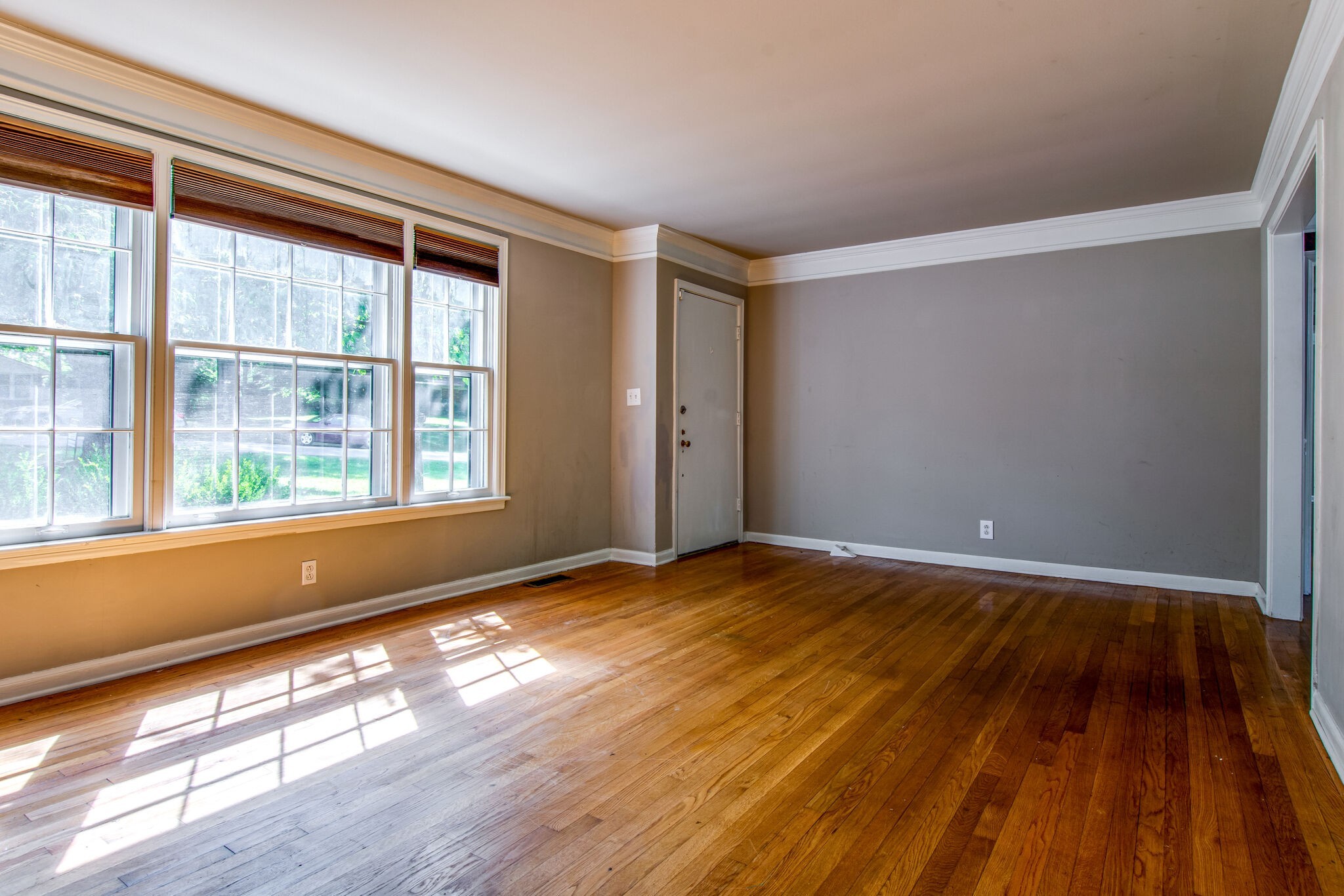2302 Deerwood Road Nashville, TN 37214 - Photo 7 of 30 a view of an empty room with wooden floor and a window