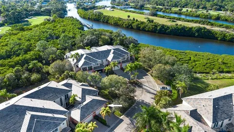an aerial view of a house with a garden and lake view