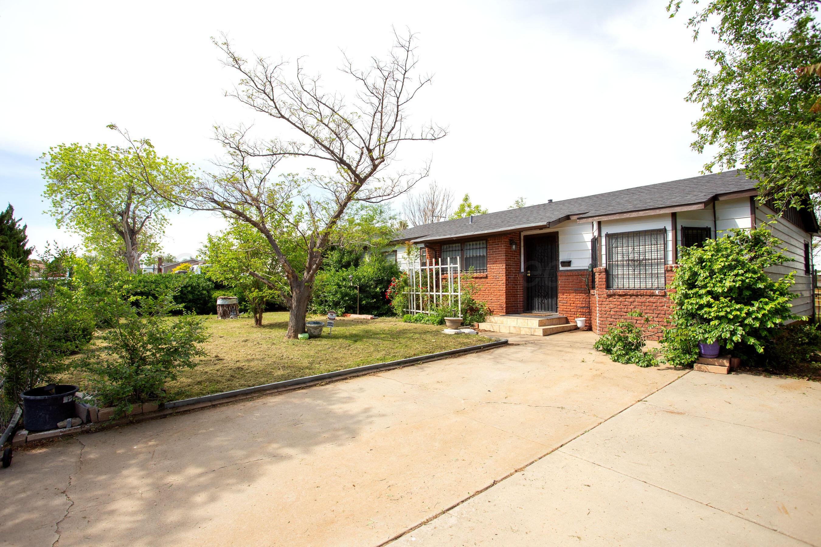 3115 Palm Street Amarillo, TX 79107 - Photo 1 of 31 a view of a house with a backyard and a tree