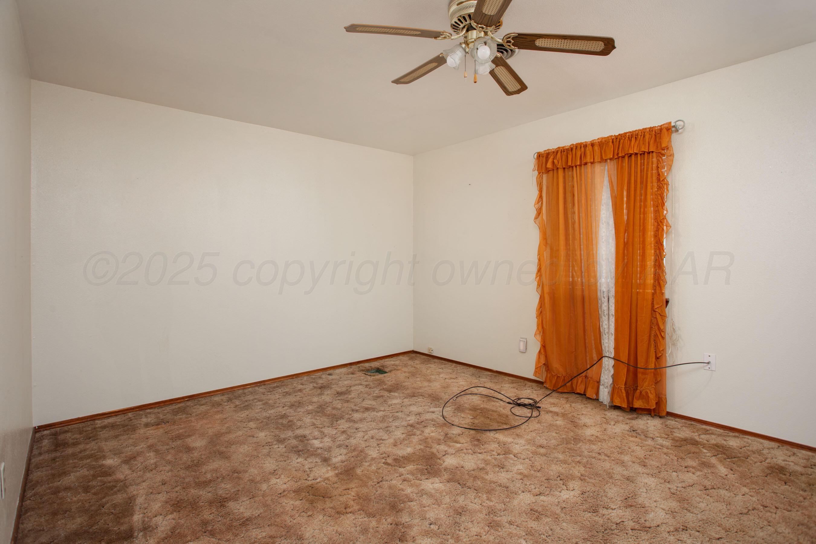 3115 Palm Street Amarillo, TX 79107 - Photo 18 of 31 an empty room with windows and fan