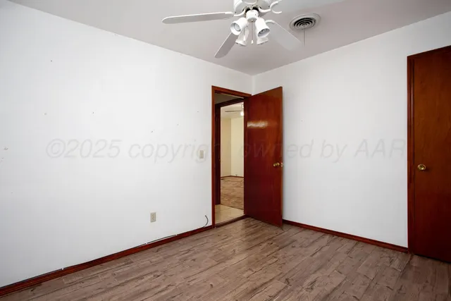 a view of a room with a ceiling fan