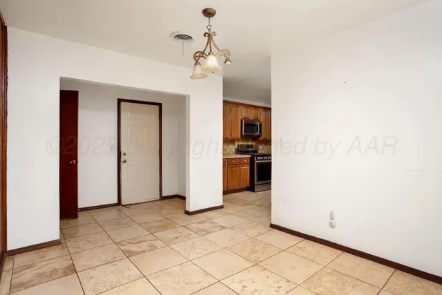 a kitchen with stainless steel appliances granite countertop a sink stove and microwave