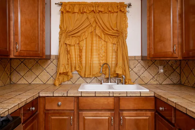 a kitchen with granite countertop a stove and a microwave