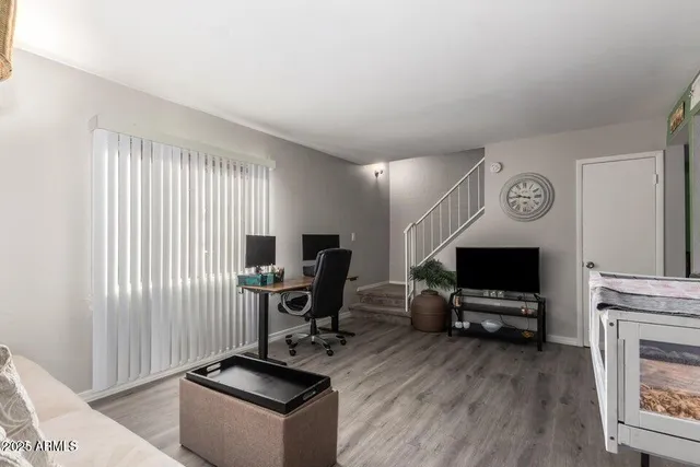 a view of workspace with wooden floor windows