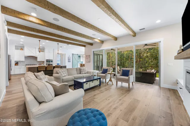 a kitchen with kitchen island white cabinets and stainless steel appliances