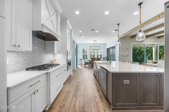 a dining room with wooden floor and windows