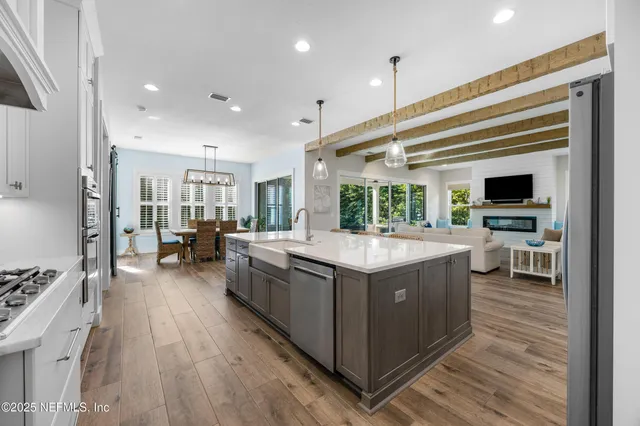 a kitchen with a stove and a wooden floor