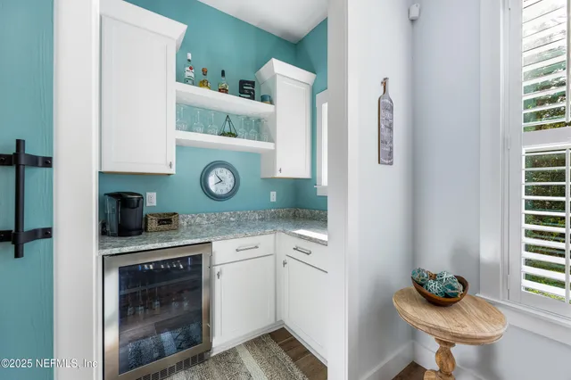 a spacious bedroom with a bed and a large window