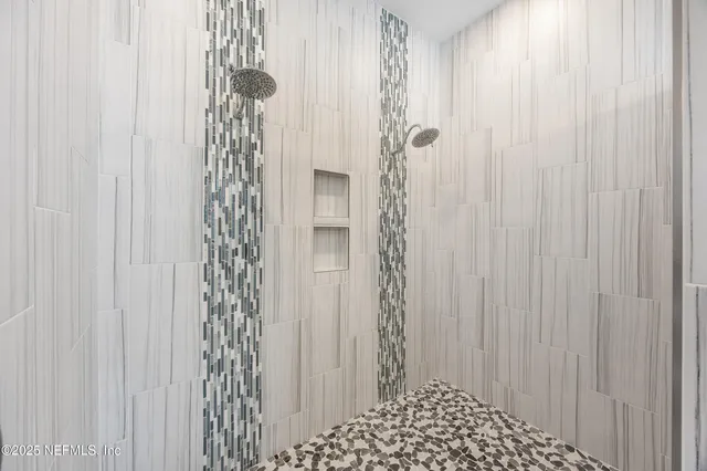 a spacious bathroom with a granite countertop tub sink and mirror