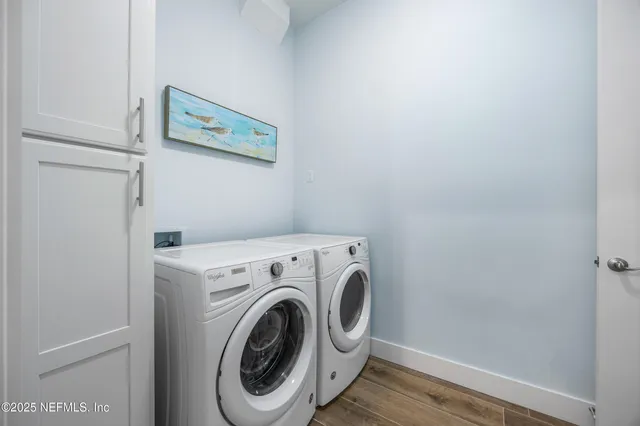 a view of a storage and utility room with washer and dryer
