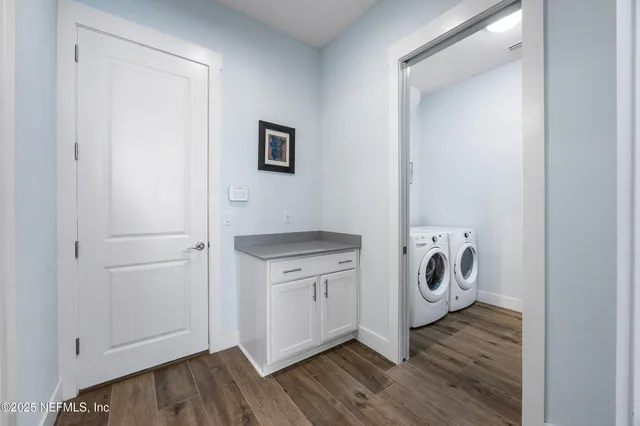 a large white kitchen with kitchen island a sink a stove and a window